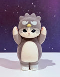 Flocked gray character figure with sleepy eyes and small yellow forehead marking