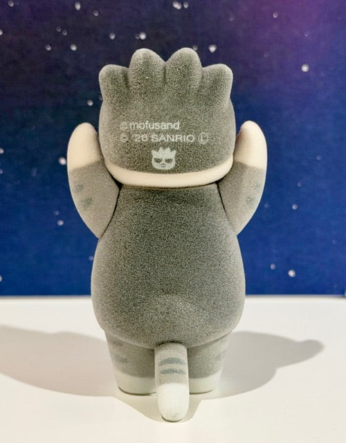 Flocked gray character figure with long ears and crest logo on chest