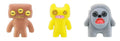 Three plush alien figures: brown, yellow, and gray with cartoon faces