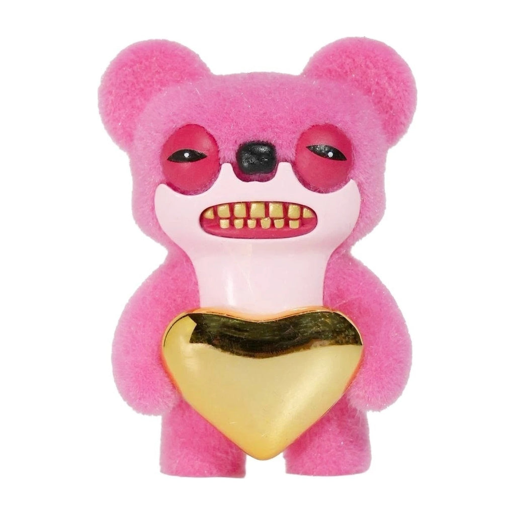Pink plush monster figure with red eyes, black nose, and gold heart belly