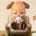 Brown and tan puppy boy blind box figure holding a small white puppy plush