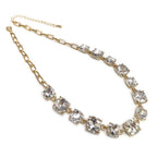 Gold-tone crystal necklace with clear cushion-cut square stones and linked chain