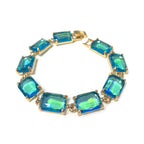 Gold-tone linked bracelet with emerald-cut blue-green crystal stones