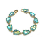 Teardrop crystal link bracelet with gold-tone settings and teal glass stones.