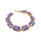 Gold-tone linked bracelet with emerald-cut purple crystal stones