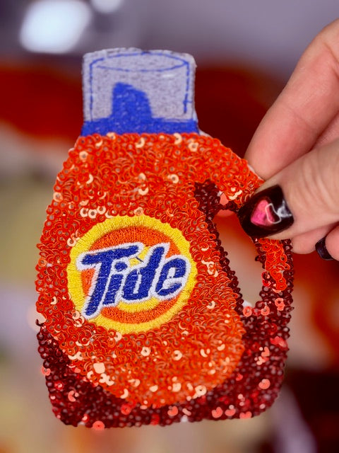 Orange sequin iron-on patch with Tide circular logo