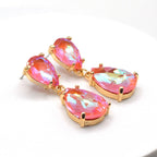 Gold-tone crystal teardrop dangle earrings with bright pink oval stones