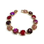 Gold-tone linked bracelet with cushion-cut crystals in red, pink, and purple