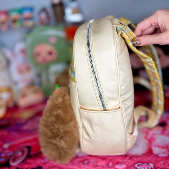Cream kids backpack back view with zipper pocket and plaid handle detail