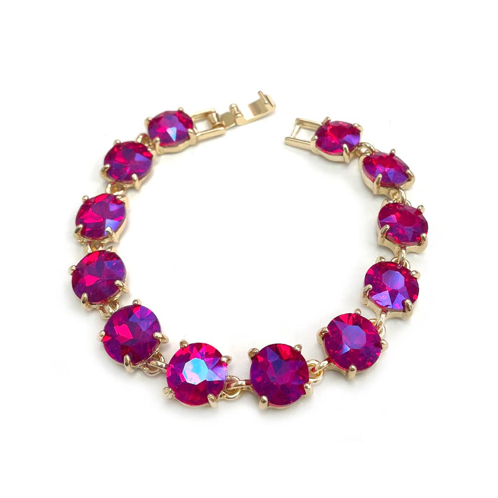 Gold-tone crystal bracelet with fuchsia round cushion stones and hinge clasp.