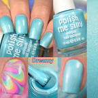Sky blue creme nail polish on manicured nails, bottle partially visible