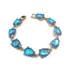 Teardrop crystal linked chain bracelet with vivid blue stones and gold-tone setting