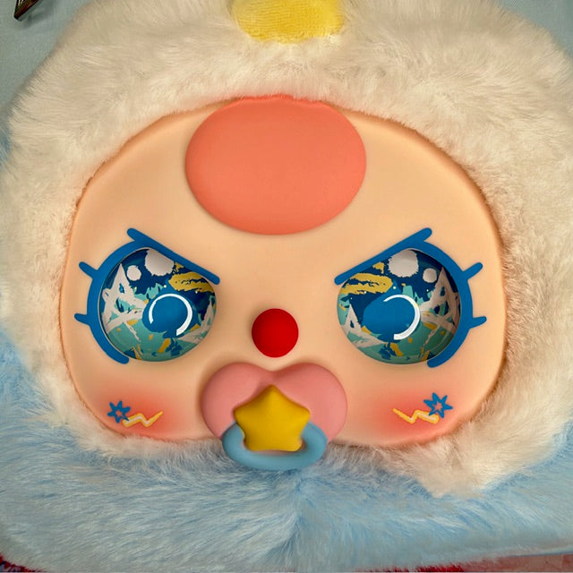 Plush character face front pocket with blue eyes and star accents on light blue