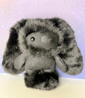 Black plush bag charm rabbit with embroidered face and metal flower-shaped badge