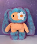 Blue plush bunny bag charm with orange belly and white flower patch
