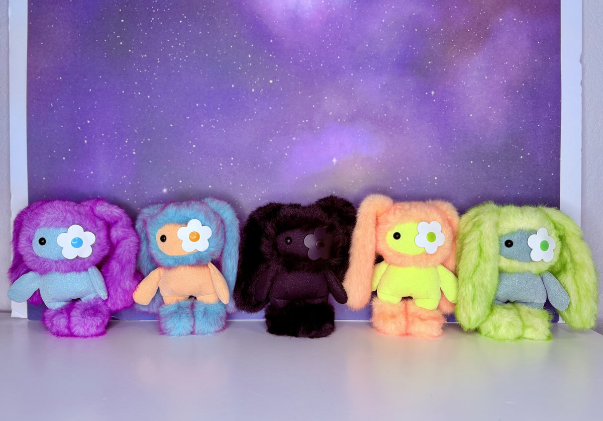 Set of five glitter plush charms in purple, orange, dark, peach, and green colors