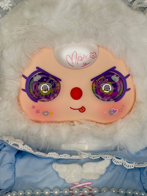 Plush baby figure face with orange cheeks, purple glitter eyes, red nose, white hood patch