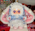 Plush baby figure in blue dress with white lace bonnet, ruffled skirt, pink boots