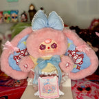 Pink and light blue plush figure holding gift tag on display box, sailor dress and bow