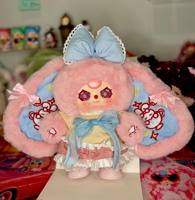 Pink and light blue plush figure on display box, sailor dress with side ribbon details