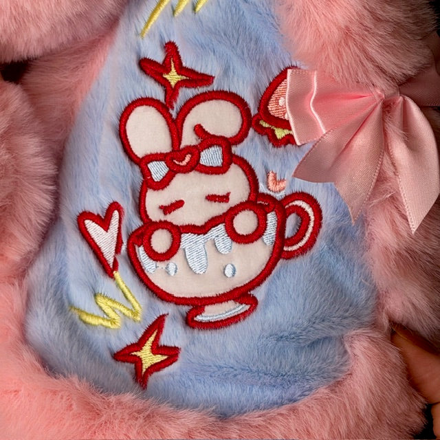 Light blue plush figure pouch with red stitched character, stars, and pink bow