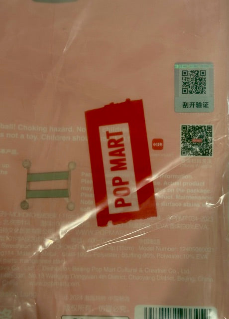 POP MART plush hair clip in clear package with red branding sleeve
