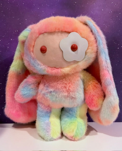 Pastel rainbow plush bunny front view, soft plush face patch with red button eyes