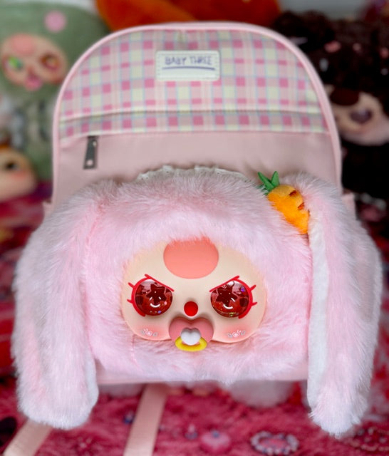 Pink plush bunny backpack with carrot detail and small top label