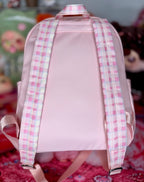 Pink backpack with plaid check straps and adjustable back support