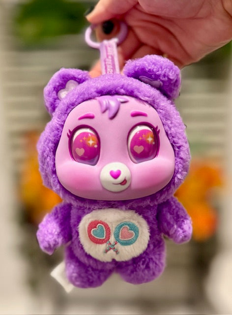 Purple plush bear keychain with heart nose and stitched paw patch