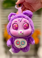 Purple plush bear keychain with heart nose and stitched paw patch