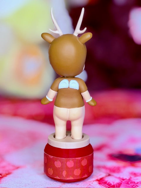 Brown reindeer character figurine with white antlers and blue belly detail on red base