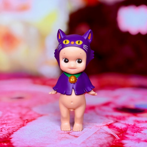 Purple cat-themed collectible figurine in Halloween outfit, front view with gold bell necklace