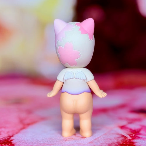 Sonny Angel cat figurine in white with pink and purple cherry blossom graphic