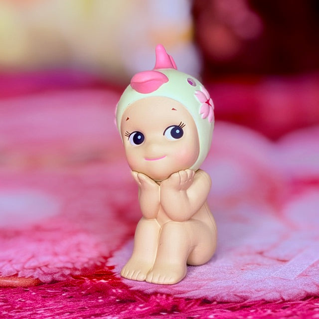 Cherry blossom collectible figurine, front view with big blue eyes and pink flower head