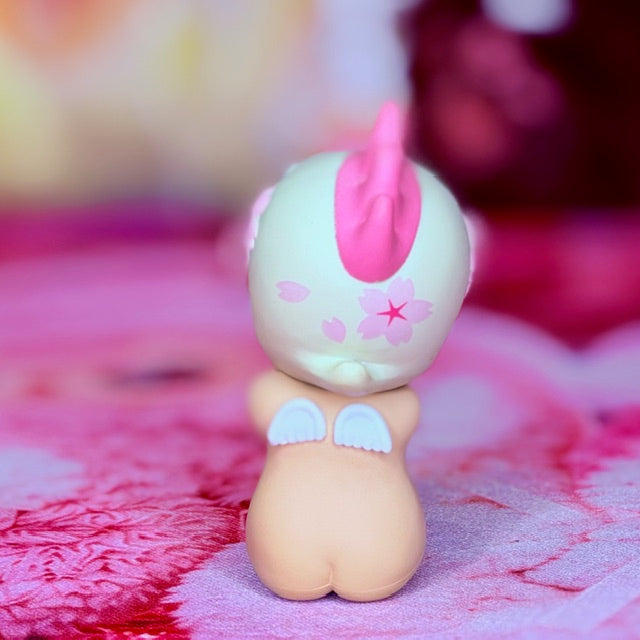 Cherry blossom collectible figurine, rear view with pink tail fin and flower emblem