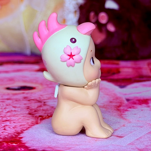 Cherry blossom collectible figurine, side view with pink horn tufts and flower chest