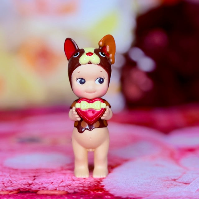 French bulldog vinyl figurine holding a red heart
