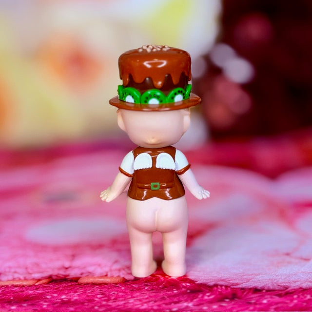 Chocolate-themed Sonny Angel figure with brown hat and green kiwi print, standing pose