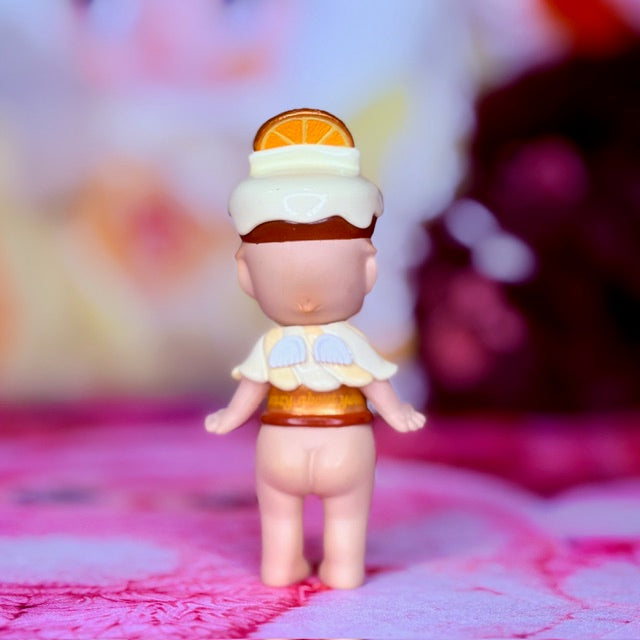 Small Sonny Angel figurine, full body, orange slice hat and white ruffle outfit