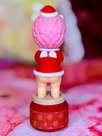 Pink hedgehog Christmas figure in red and white outfit on rotating base