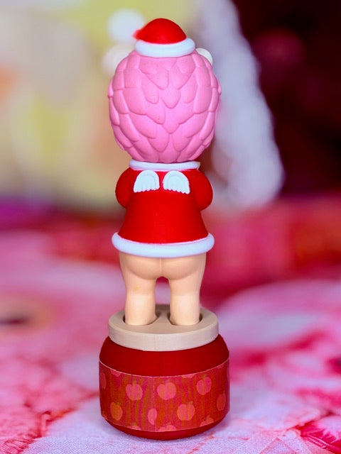 Pink hedgehog Christmas figure in red and white outfit on rotating base