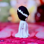 Custom vinyl doll in white gown with dark purple hair and white headband, side view.