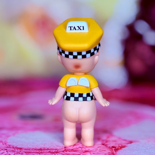 Yellow taxi-themed vinyl figure with 'TAXI' cap and checkered outfit