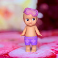 Sonny Angel swimmer figurine standing with purple goggles and purple swim trunks