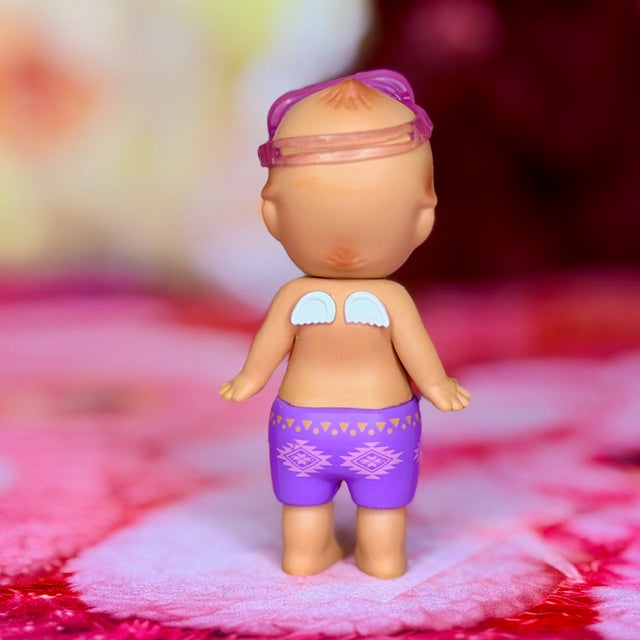 Sonny Angel swimmer figurine with purple goggles and purple patterned swim trunks
