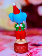 Sonny Angel elephant figurine with green outfit and red Santa hat
