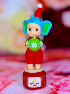Sonny Angel elephant figurine holding green cookie, on red Apple Pie Jam base