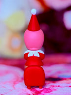 Santa helper figurine with red hat and red outfit, showing shoes and green belt details