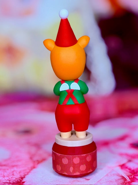 Pig Santa’s Little Helper figurine in red outfit, green belt, on Apple Pie Jam base